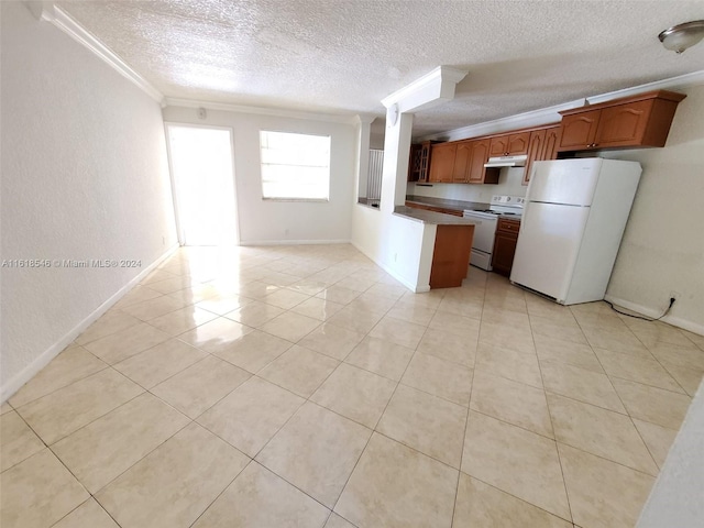 kitchen featuring ornamental molding, light tile patterned flooring, a textured ceiling, and white appliances