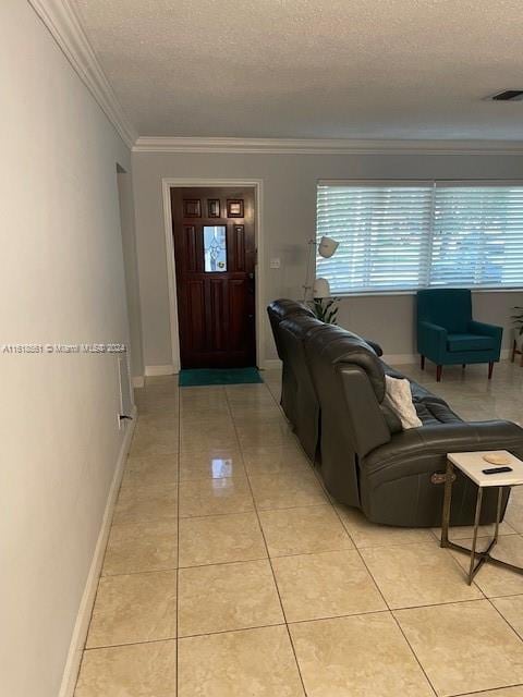 living room featuring light tile patterned flooring, a textured ceiling, and ornamental molding