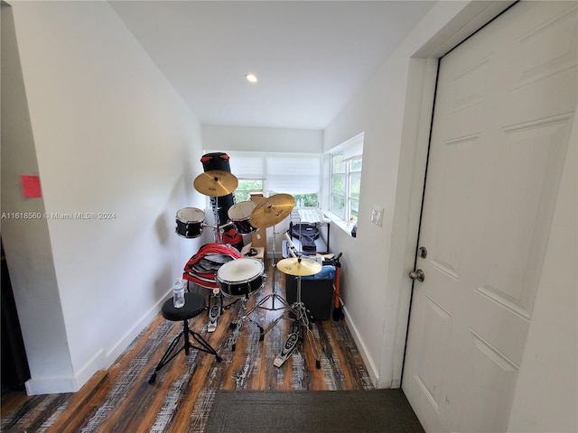 misc room with dark hardwood / wood-style flooring and vaulted ceiling