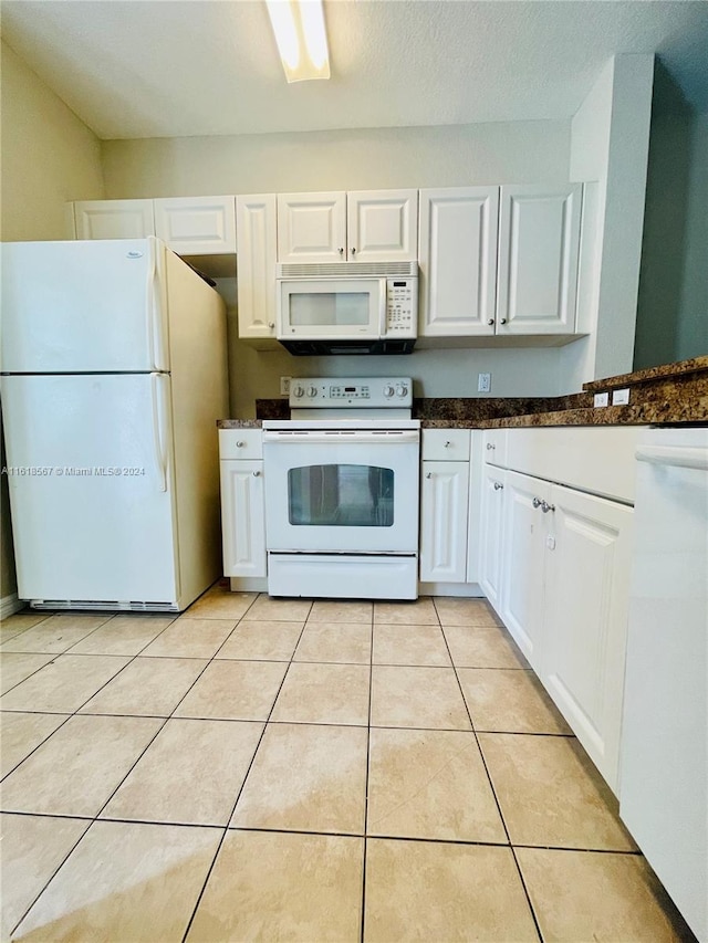 kitchen featuring white cabinets, white appliances, and light tile patterned floors