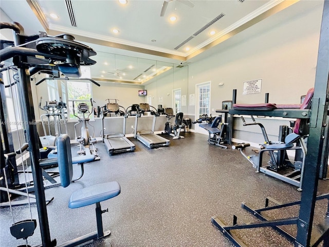 exercise room featuring ceiling fan, crown molding, and a tray ceiling