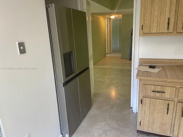 hall featuring light tile patterned flooring