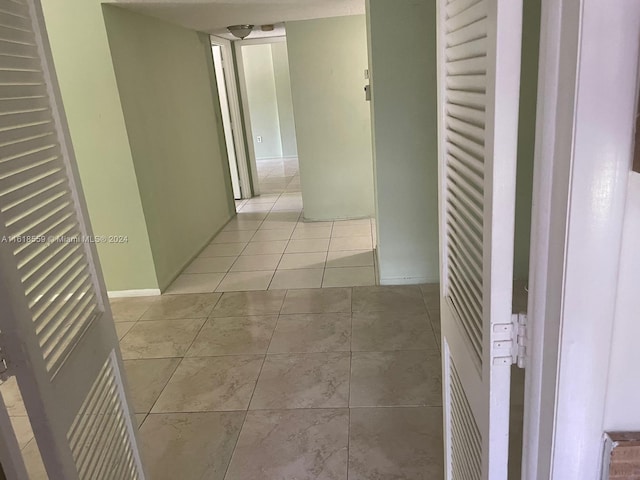 hallway with light tile patterned floors