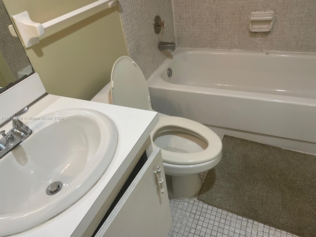 full bathroom featuring toilet, vanity, tile patterned floors, and tiled shower / bath combo