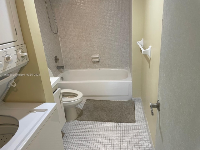 full bathroom with toilet, vanity, tile patterned floors, tiled shower / bath, and stacked washer and dryer