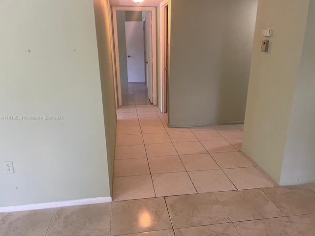 hall with light tile patterned flooring