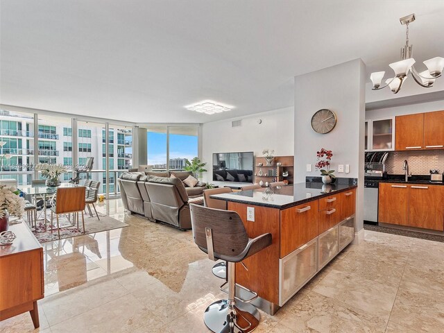 kitchen with stainless steel appliances, pendant lighting, backsplash, a kitchen breakfast bar, and tile patterned floors