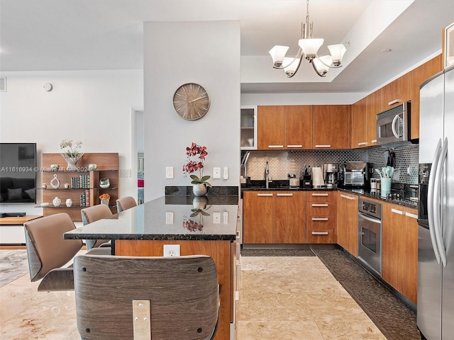 kitchen with stainless steel appliances, tile patterned flooring, backsplash, decorative light fixtures, and a kitchen breakfast bar