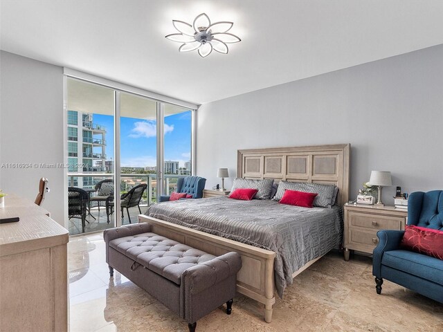 bedroom with light tile patterned floors, access to outside, and expansive windows