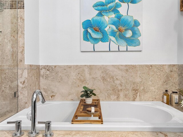 bathroom featuring tiled tub