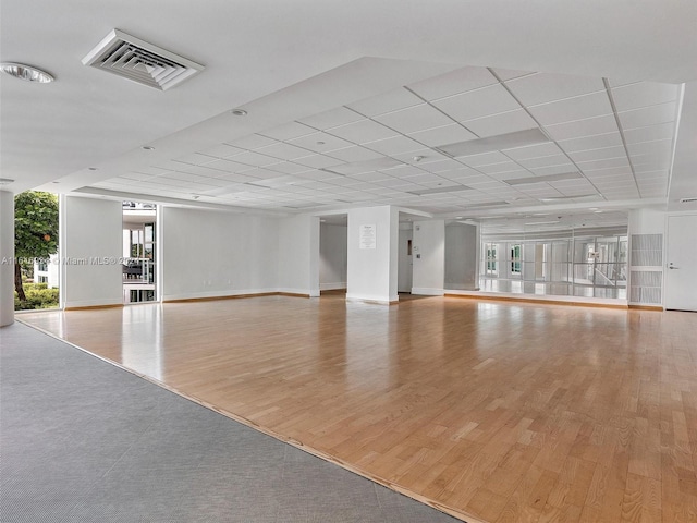 unfurnished living room featuring expansive windows and light wood-type flooring