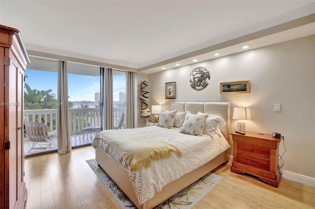 bedroom with access to exterior, baseboards, wood finished floors, and recessed lighting