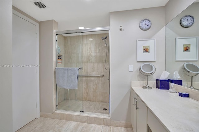 bathroom featuring a stall shower, vanity, and visible vents