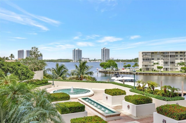 exterior space with a water view and a city view