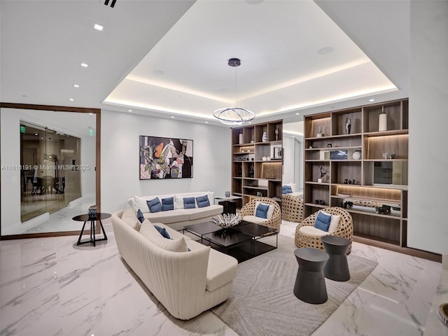 living area featuring recessed lighting, a raised ceiling, and marble finish floor