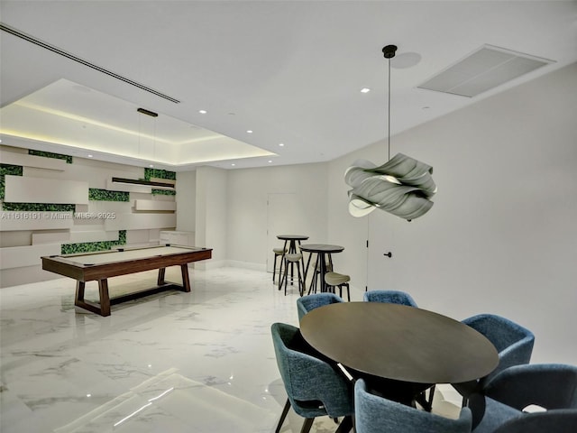 recreation room featuring visible vents, baseboards, marble finish floor, a tray ceiling, and recessed lighting