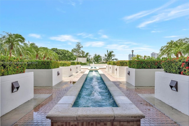 view of swimming pool featuring a patio area and fence