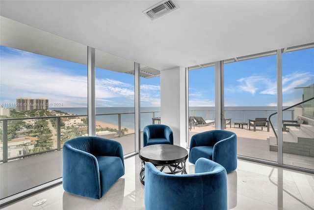 sunroom / solarium featuring a water view