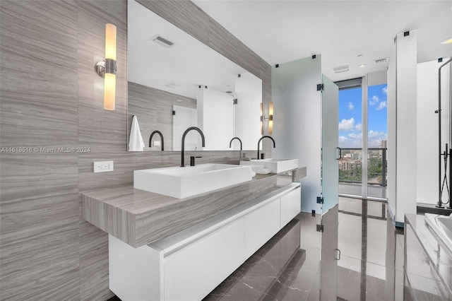 bathroom with floor to ceiling windows, plus walk in shower, tile patterned flooring, and vanity