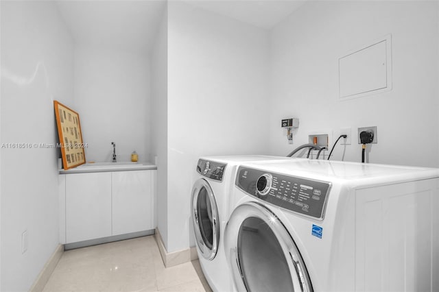 clothes washing area with washing machine and clothes dryer and light tile patterned floors