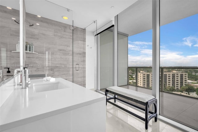 bathroom featuring walk in shower, tile patterned floors, and sink