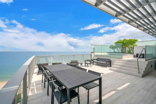 wooden deck with an outdoor hangout area and a water view