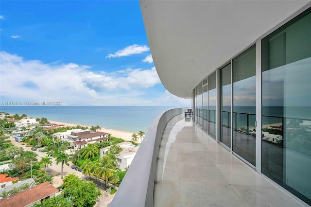 balcony with a water view and a beach view