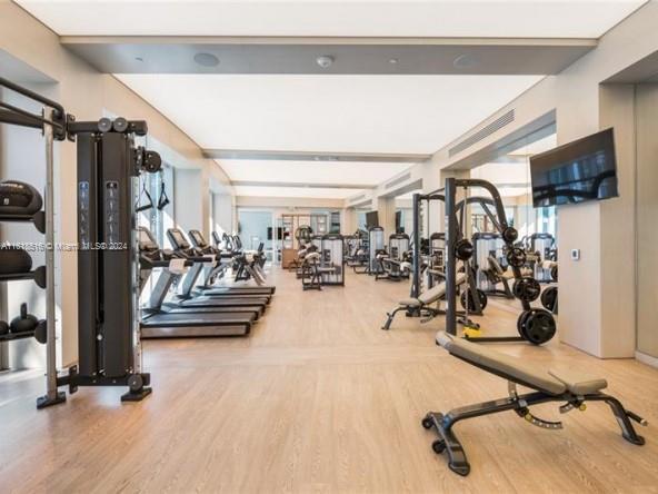 exercise room with hardwood / wood-style flooring