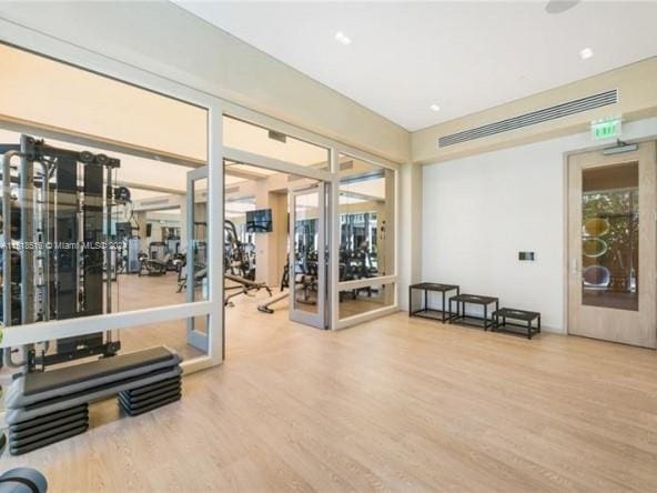 exercise room featuring hardwood / wood-style floors