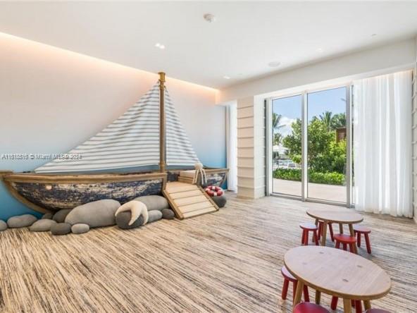 recreation room featuring light colored carpet