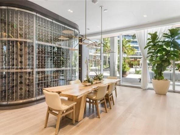 dining area with wood-type flooring and floor to ceiling windows