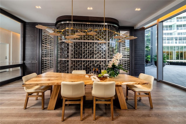 wine room with hardwood / wood-style flooring and floor to ceiling windows