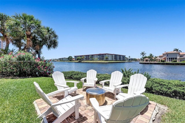 view of patio with a fire pit and a water view