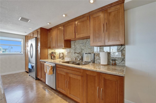 kitchen with light tile patterned flooring, sink, appliances with stainless steel finishes, and backsplash