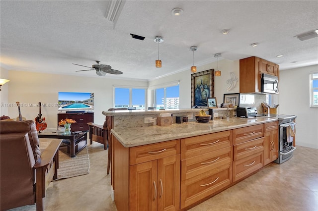 kitchen featuring appliances with stainless steel finishes, decorative light fixtures, ceiling fan, and plenty of natural light