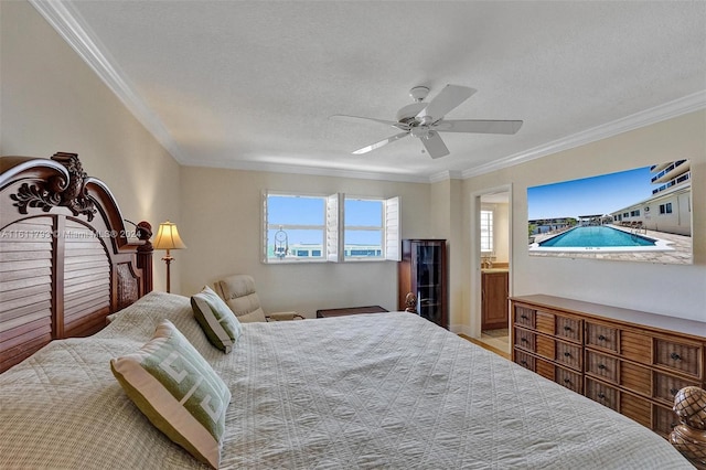 bedroom with a textured ceiling, ceiling fan, connected bathroom, and ornamental molding