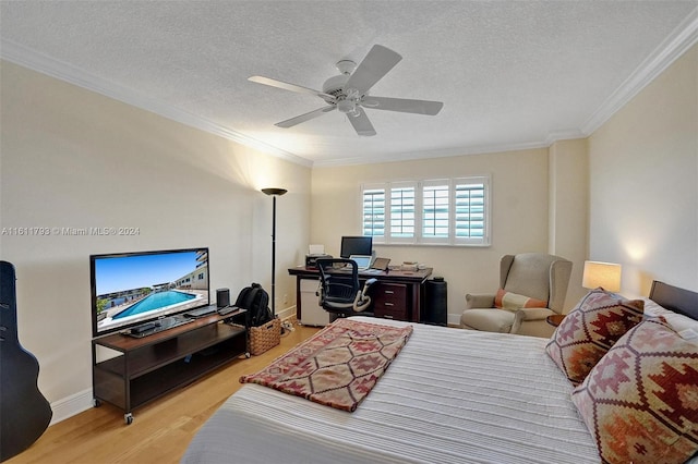 bedroom with a textured ceiling, crown molding, hardwood / wood-style floors, and ceiling fan