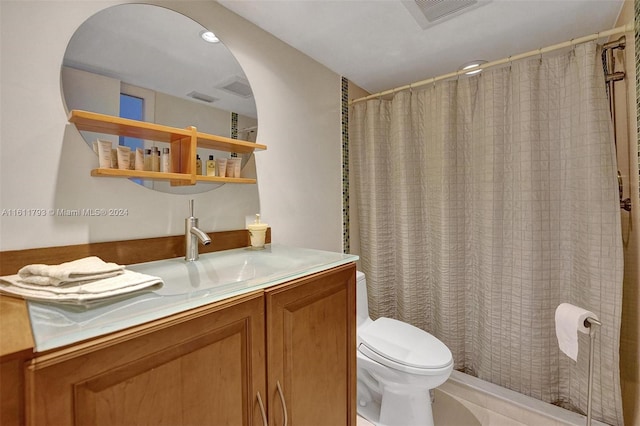 bathroom with tile patterned flooring, toilet, and vanity