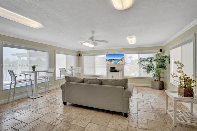 living room with ornamental molding, light tile patterned floors, a textured ceiling, and ceiling fan