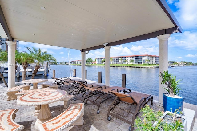 view of patio / terrace featuring a boat dock and a water view