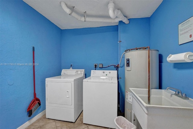 laundry room featuring sink, light tile patterned flooring, electric water heater, and independent washer and dryer