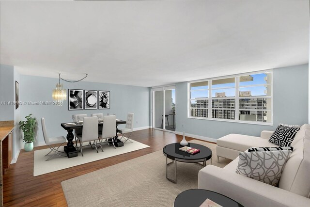 living room featuring hardwood / wood-style flooring and an inviting chandelier