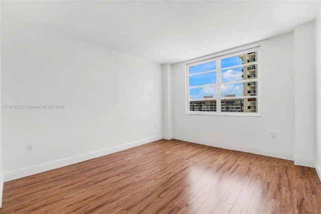 unfurnished room featuring hardwood / wood-style floors