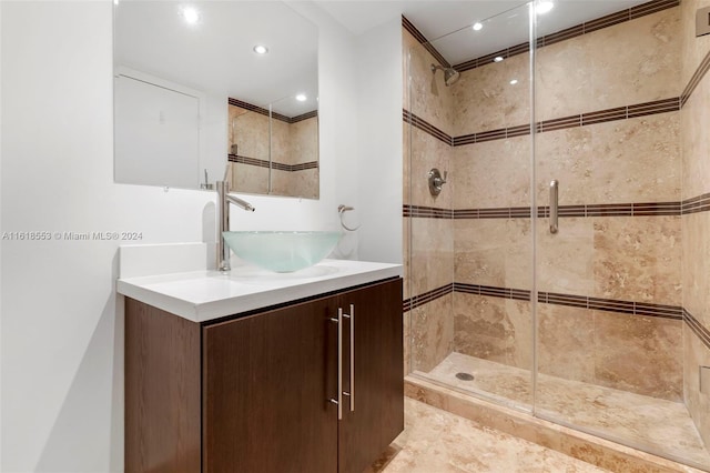 bathroom with tile patterned floors, vanity, and a tile shower