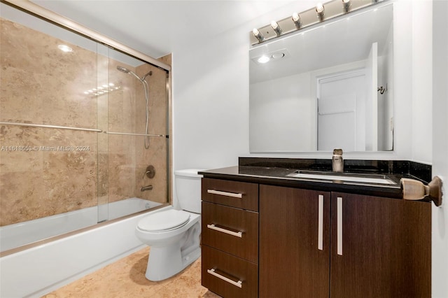 full bathroom with toilet, tile patterned floors, shower / bath combination with glass door, and vanity