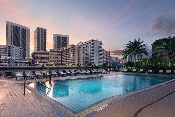 view of pool at dusk