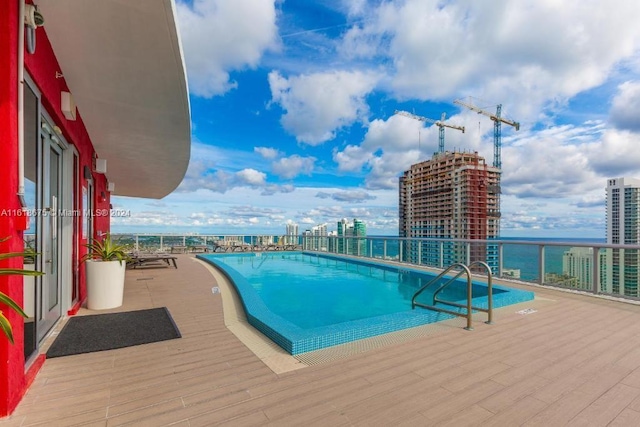 view of swimming pool with a water view