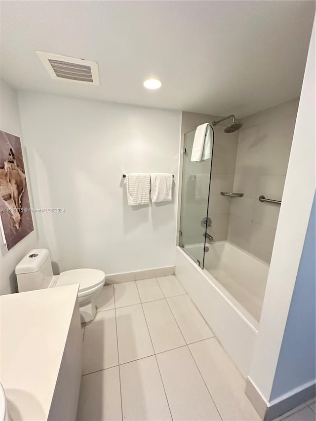 full bathroom with tile patterned floors, toilet, combined bath / shower with glass door, and vanity