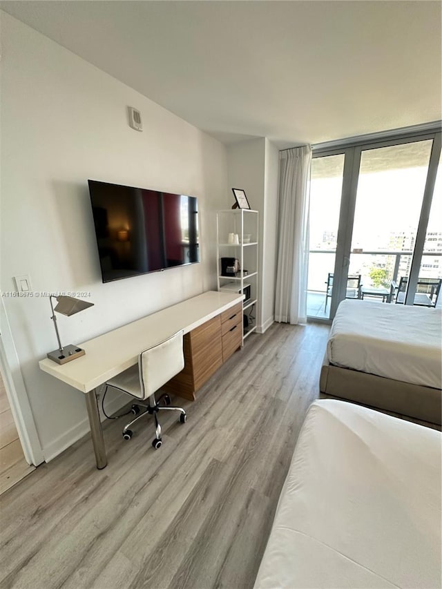 bedroom featuring light hardwood / wood-style flooring and access to outside