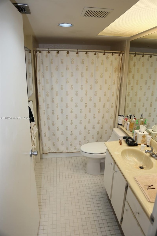 bathroom with tile patterned floors, toilet, and vanity